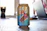 A soda can featuring a cartoon character on a skateboard, emblazoned with the words 'Exotic Soda'. The can is placed on a wooden surface with a blurred background, possibly a room with a laptop.