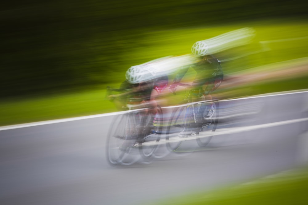 motion photography of two men riding mountain bikes