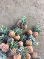 Bright yellow pineapple fruit chips scattered on a wooden table