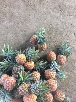 Bright yellow pineapple fruit chips scattered on a wooden table