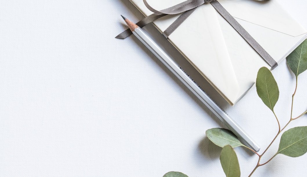 flat lay photo of book and pencil