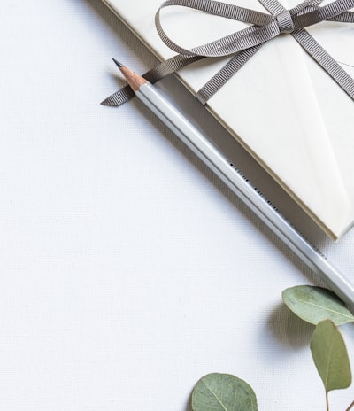 flat lay photo of book and pencil