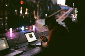 person facing laptop inside room