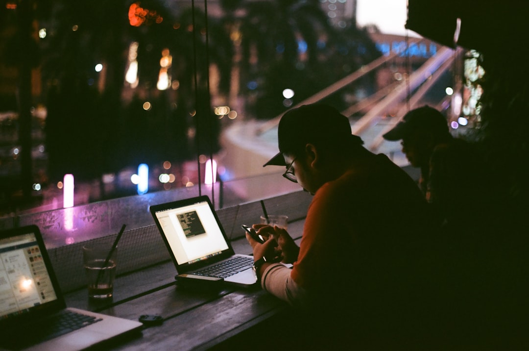 People working late by the windows of a cafe at night