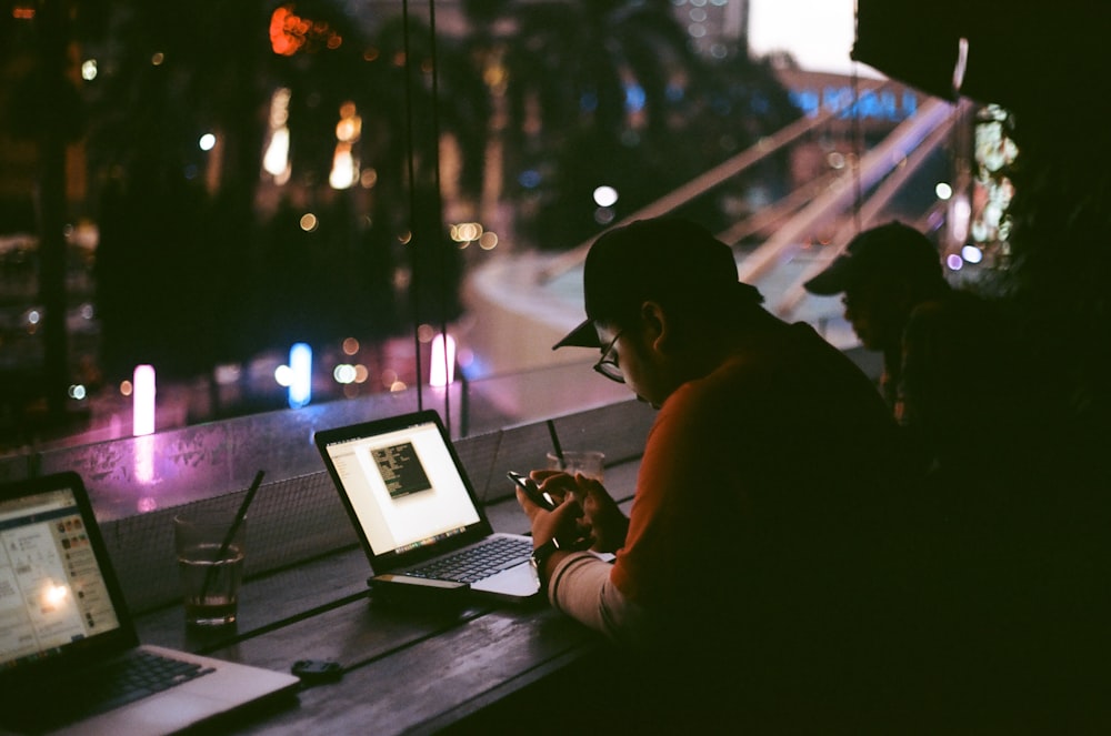 person facing laptop inside room