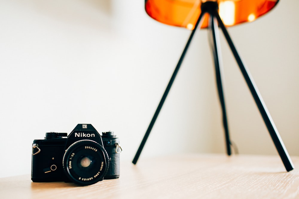 closeup photo of Nikon camera on wooden surface