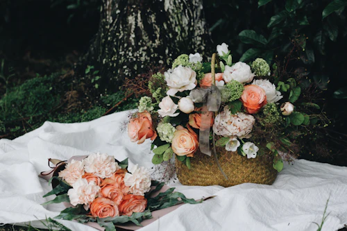 Roses and peonies arranged in a woven hamper basket