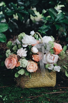 bouquet of white and pink flowers in basket