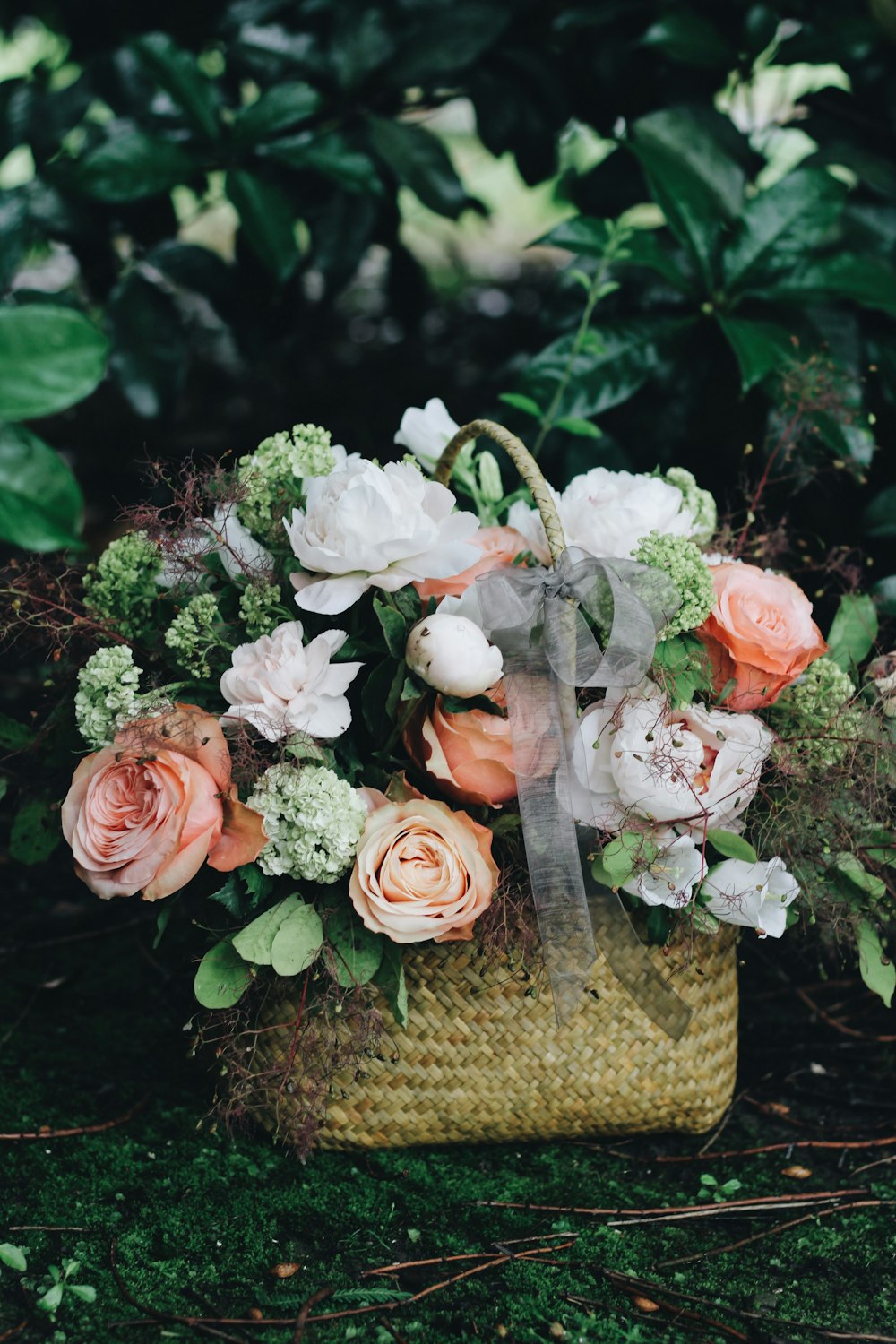 bouquet of white and pink flowers in basket