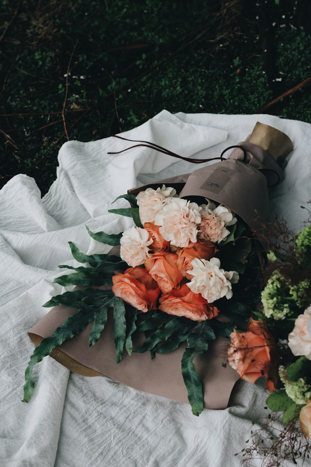 orange and pink petaled flower bouquet on table