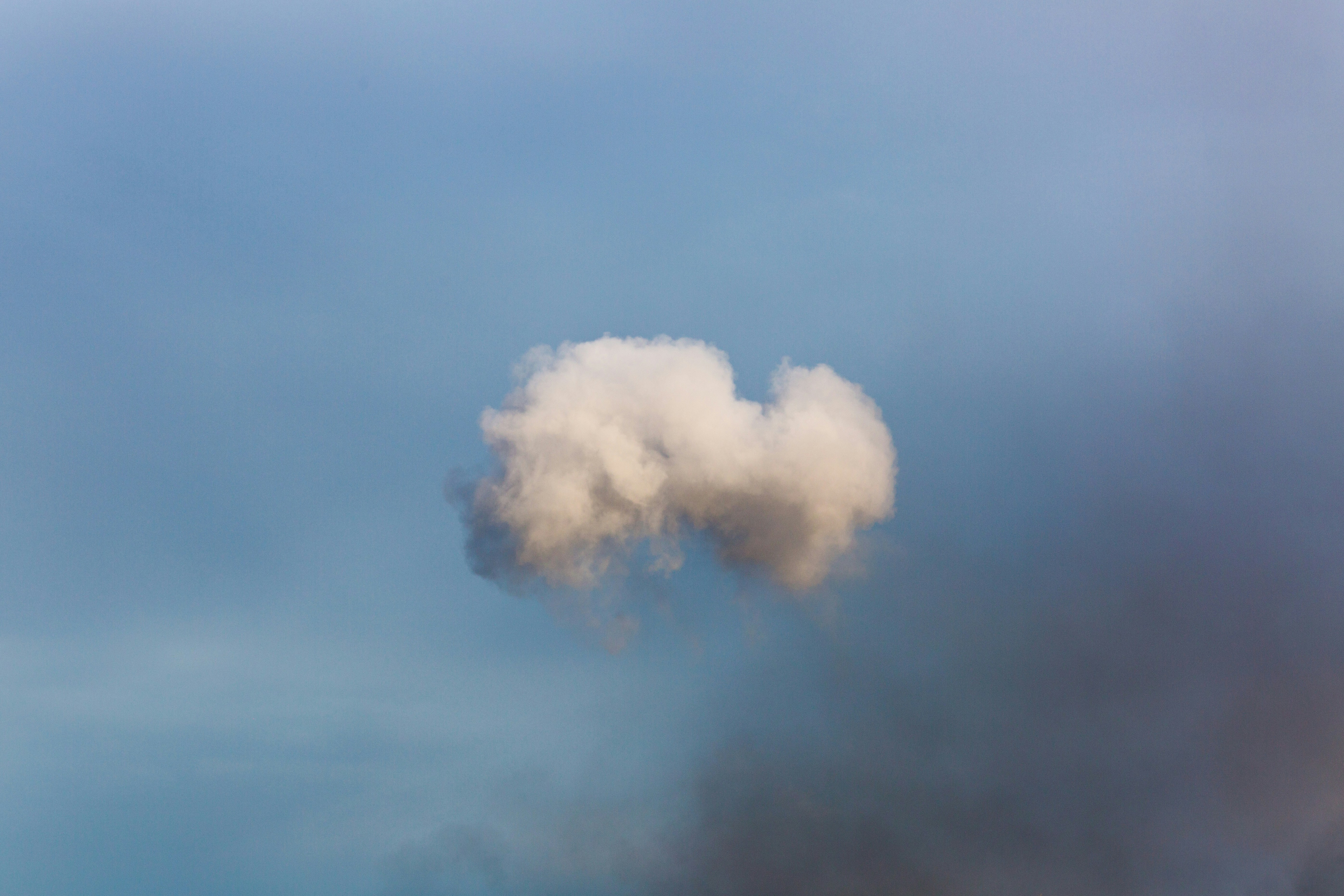 a large cloud of smoke is in the sky