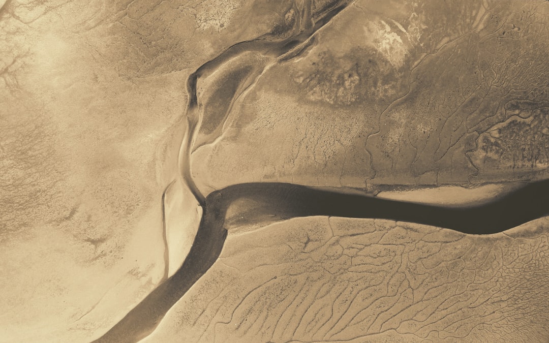 brown desert on top view, River in an arid plain