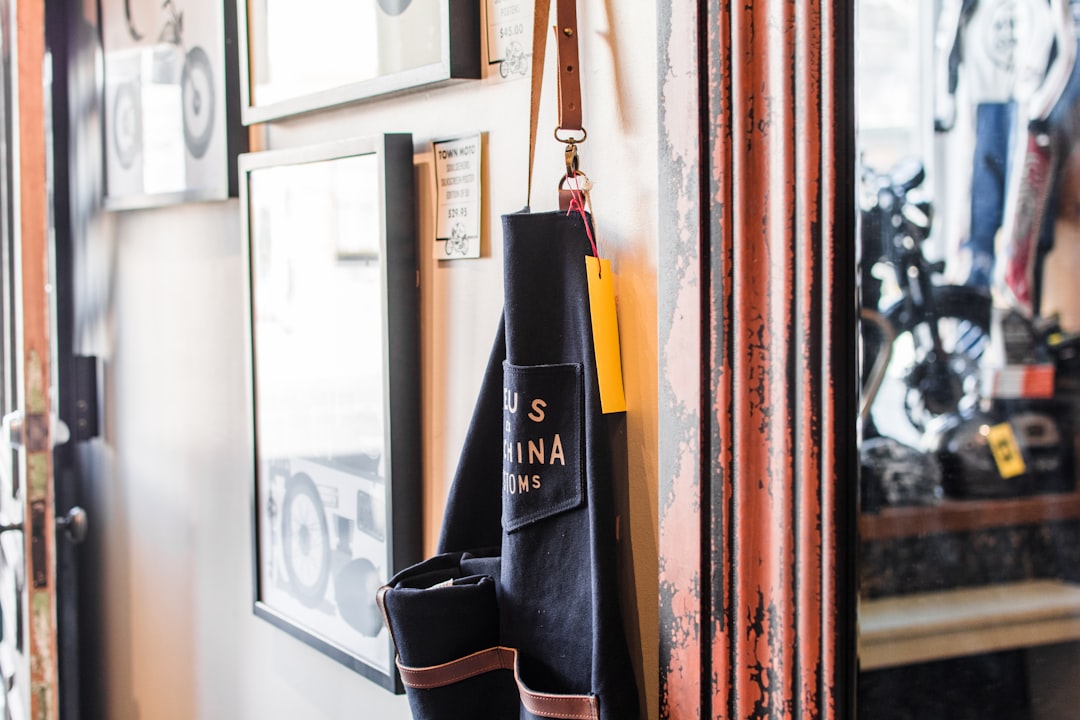 black and brown bag hanged beside wall