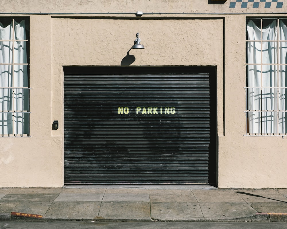 black metal roll-up door with no parking print