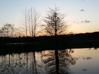 A calming image of a tranquil lake at sunset.