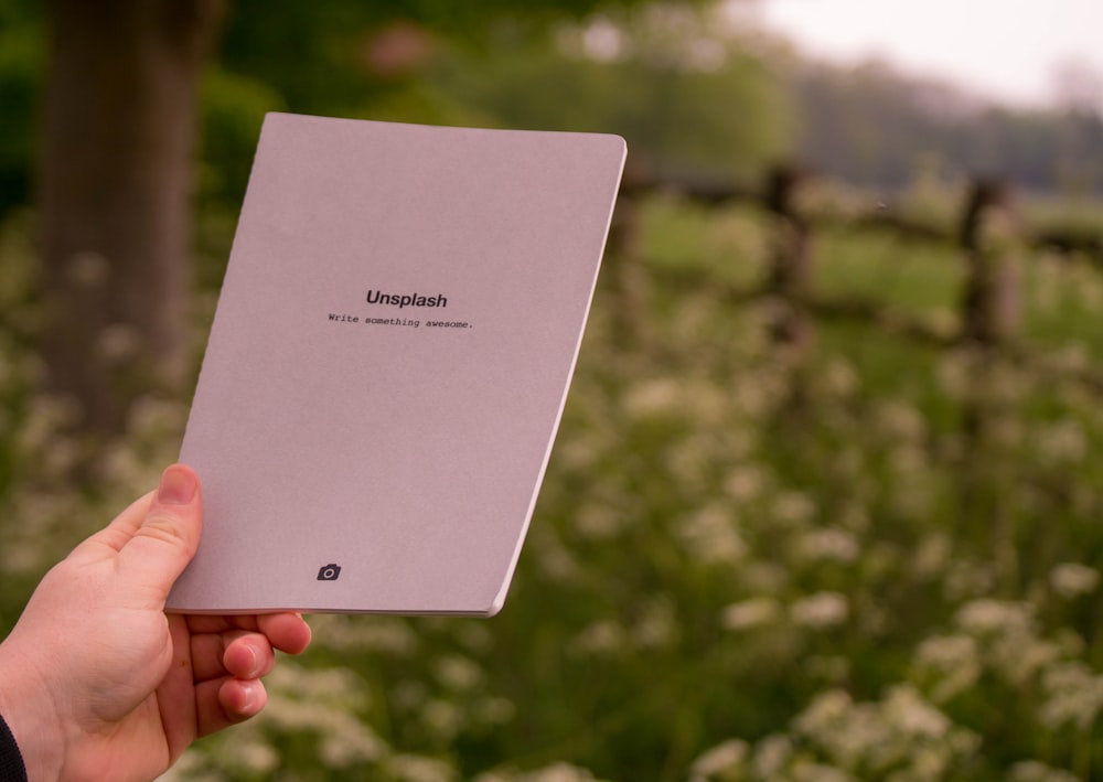 person holding white printer paper