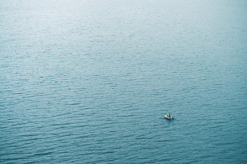 person in boat sailing at daytime