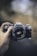 person holding black Canon DSLR camera