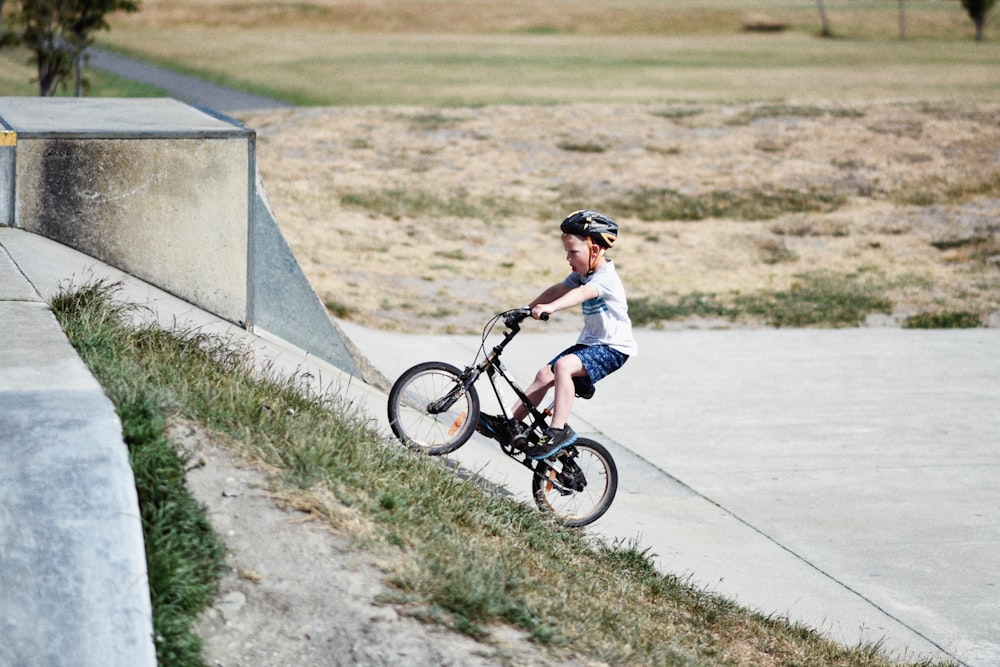 5-year-old boy with a helmet riding a 14" kids bike