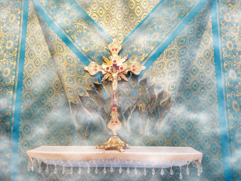 A serene navy blue and gold themed banner with a glowing cross and family silhouettes in prayer.