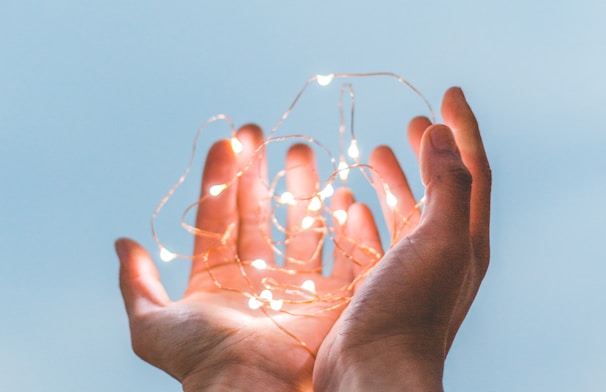 person holding string lights