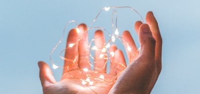 person holding string lights