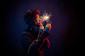 man in black jacket holding spark