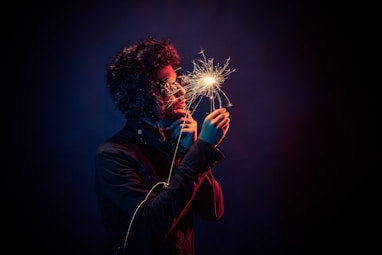 man in black jacket holding spark