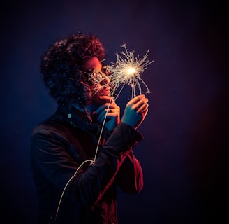 man in black jacket holding spark