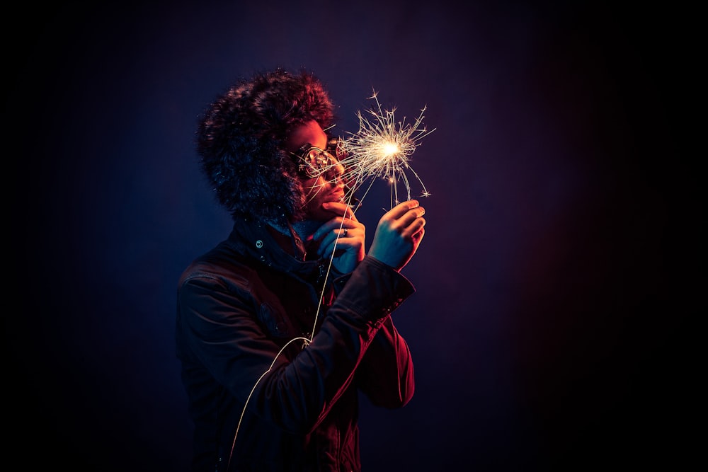 man in black jacket holding spark