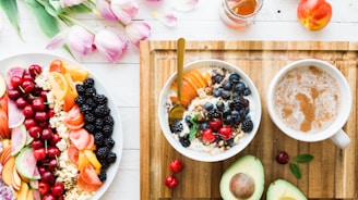 black and red cherries on white bowl