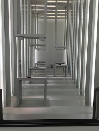 Close-up of sleek aluminum wallframes arranged artistically against a minimalist background