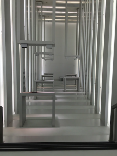 Close-up of sleek aluminum wallframes arranged artistically against a minimalist background