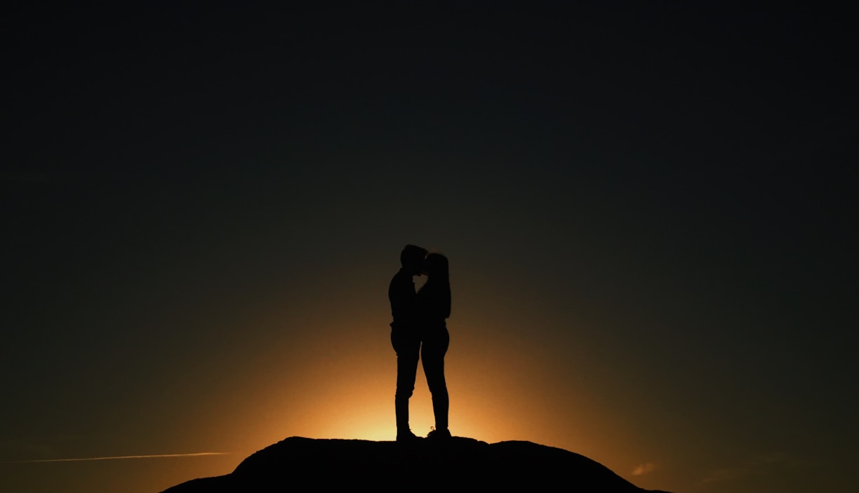 man and woman kissing