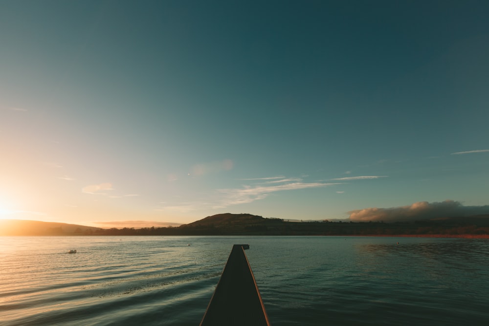 the sun is setting over a body of water