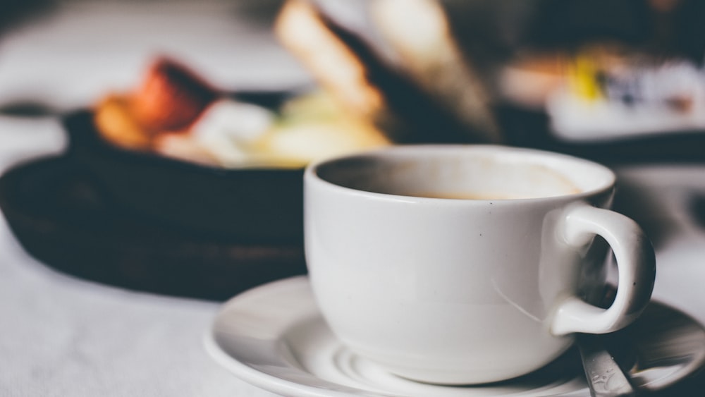 white ceramic mug on saucer