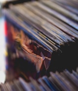 Close-up of vintage vinyl records stacked beside a microphone.