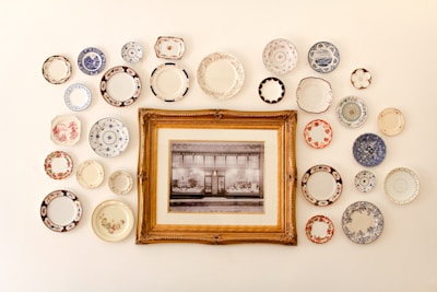photo frame near assorted-color ceramic dishes