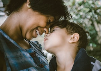 selective focus photography of woman and boy