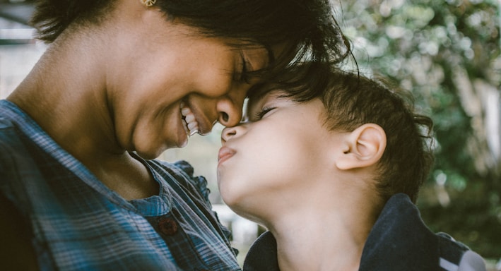 selective focus photography of woman and boy