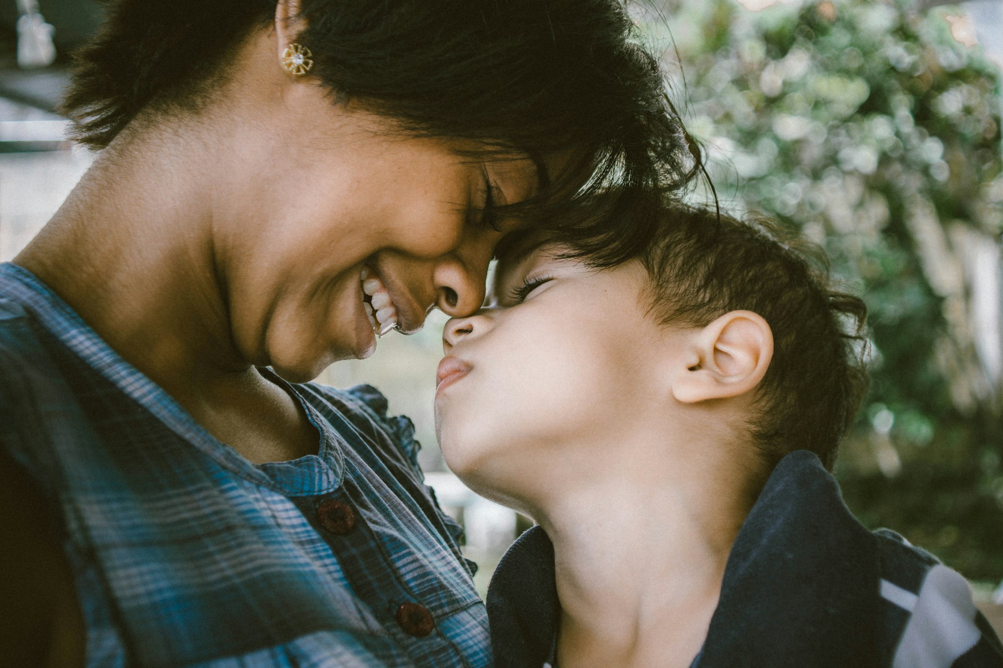 Woman and child touching faces