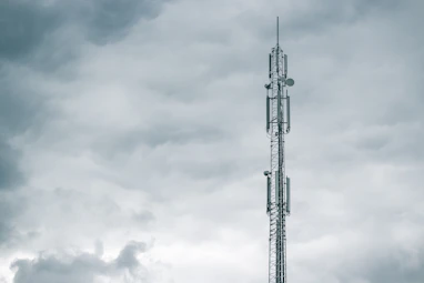 gray radio tower under the cloudy sky during daytime