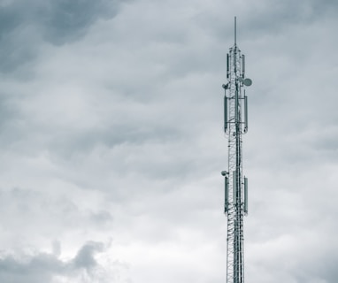 gray radio tower under the cloudy sky during daytime