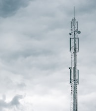 gray radio tower under the cloudy sky during daytime