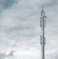 gray radio tower under the cloudy sky during daytime