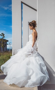 A modern bride in a sleek, minimalist wedding dress against an urban backdrop.
