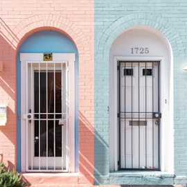 two white wooden doors with grills