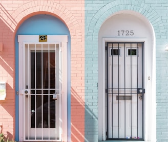 two white wooden doors with grills