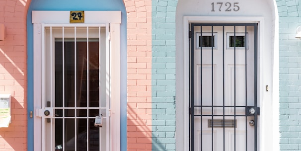 two white wooden doors with grills