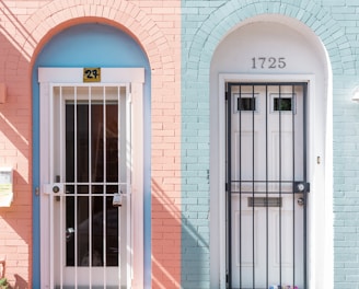 two white wooden doors with grills